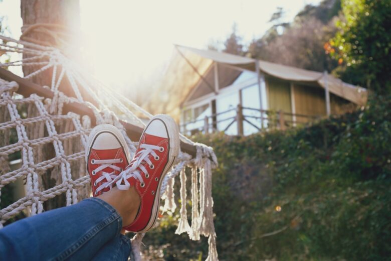 Cropped,Shot,Of,Female,Feet,Lying,On,The,Net,Hammock