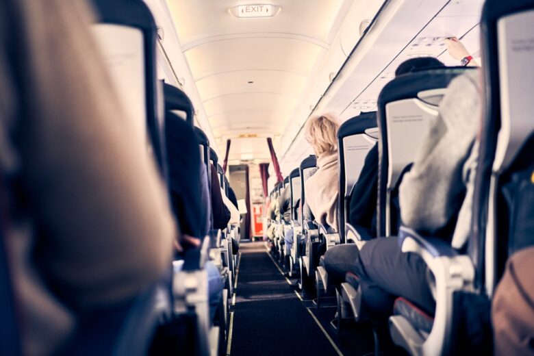 Unrecognizable,People,In,The,Cabin,Of,A,Commercial,Aircraft,With