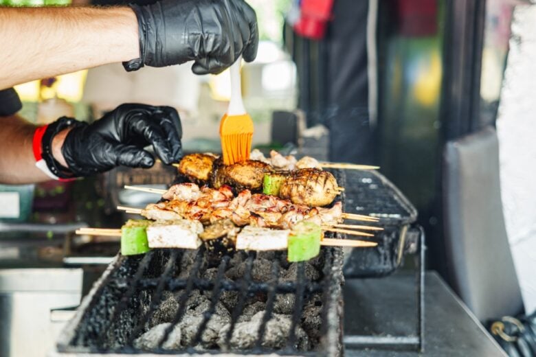 Grilled,Barbecue,Feast:,Man,Preparing,Smoked,Chicken,And,Vegetables,At