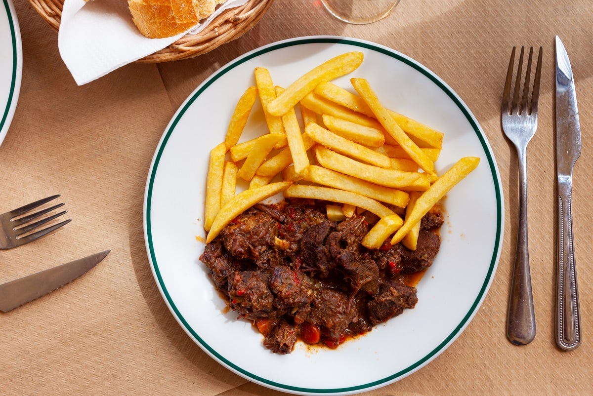 Wild,Boar,With,Spicy,Sauce,Served,With,French,Fries,On Wild,Boar,With,Spicy,Sauce,Served,With,French,Fries,On