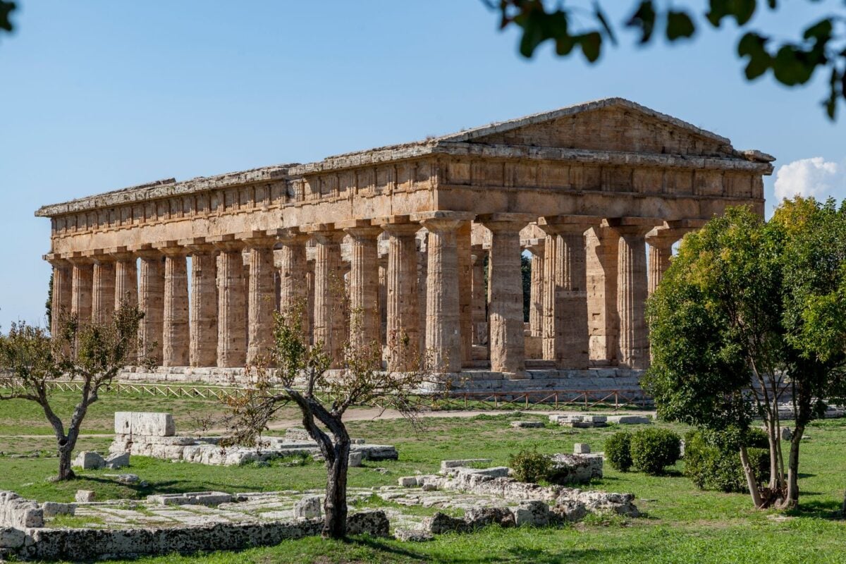 Stunning view of the ancient Temple of Hera in Paestum, Italy, with clear skies.