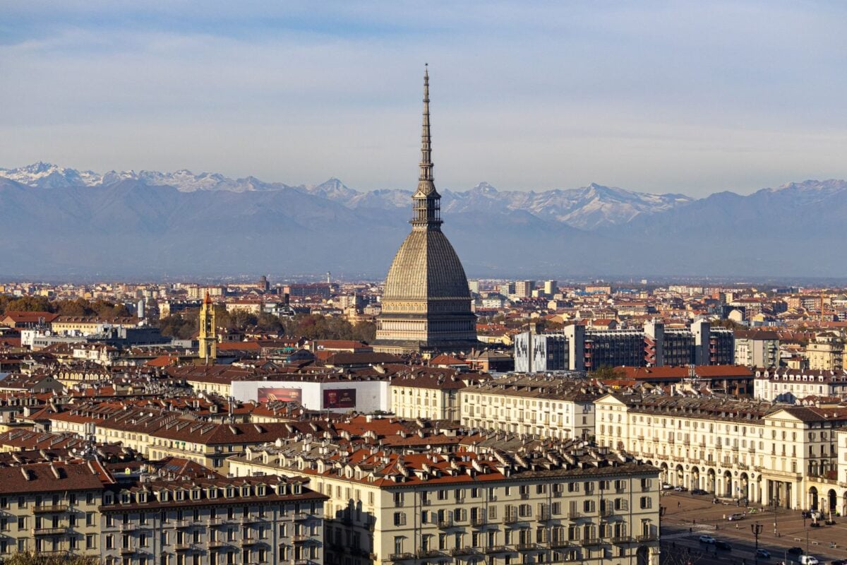 Discover the stunning cityscape of Turin with the iconic Mole Antonelliana and the Alps in the background. Discover the stunning cityscape of Turin with the iconic Mole Antonelliana and the Alps in the background.
