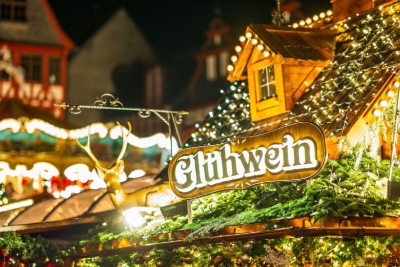 Warm and vibrant Christmas market scene showcasing a Gluhwein stall adorned with festive lights and decorations.